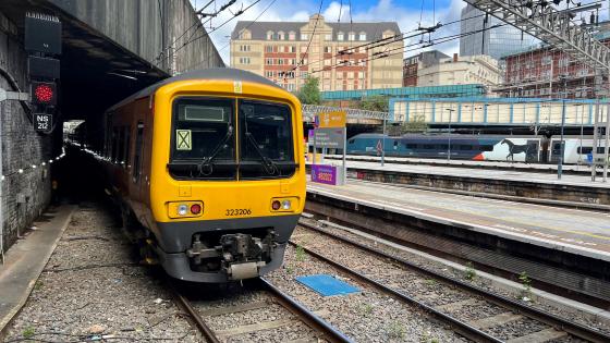 A WMR Class 323 stands next to one of the new LED signals at Birmingham New Street